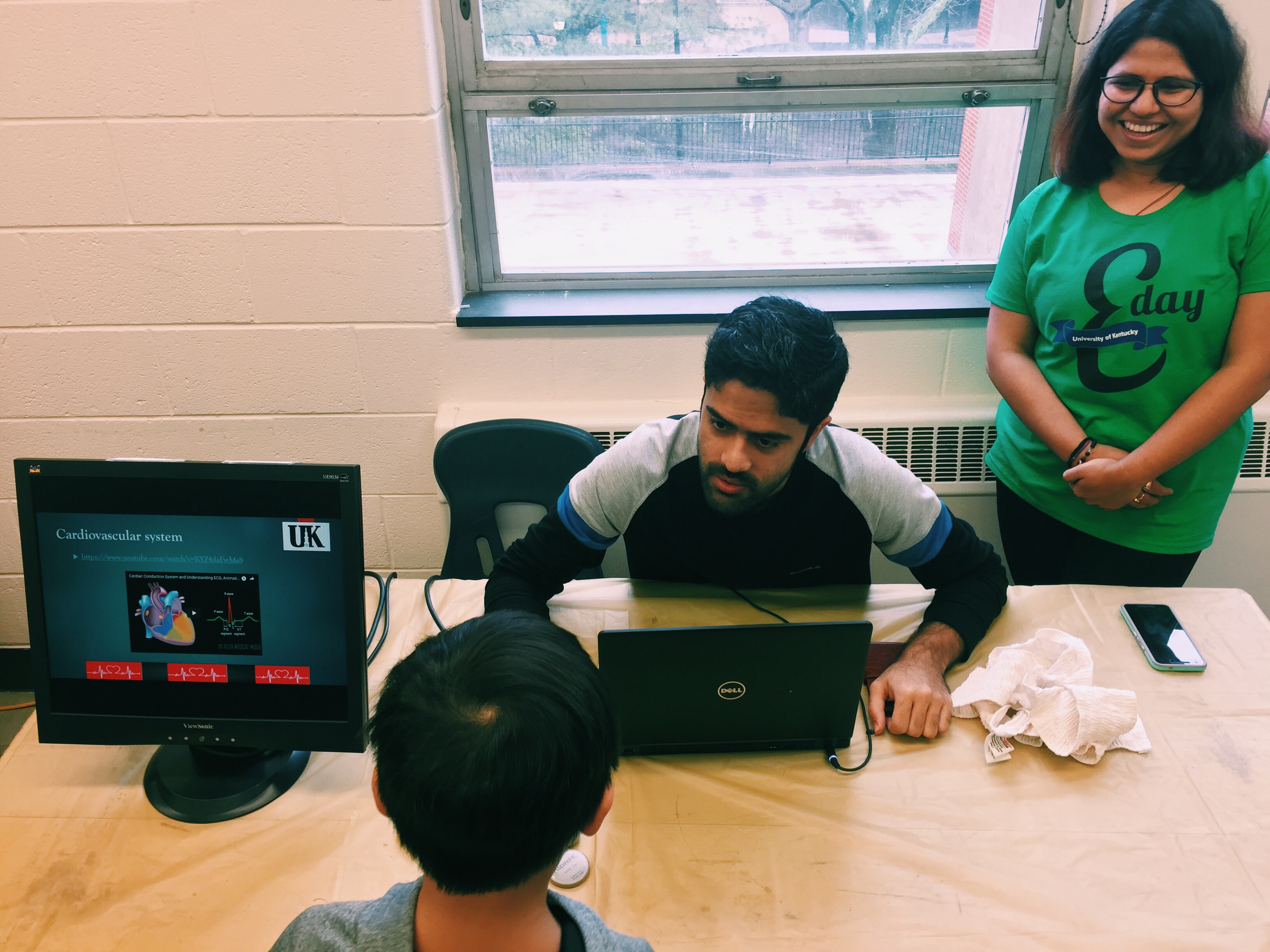 Javad Mollakazemi (left) and Dibyajyoti Biswal (right) educated E-day attendees on the electrical activity of the heart and how it can be monitored.