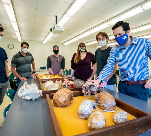 (From left) James Keppeler, Daniel Benitez, Marcus Rodriguez, Leah Blair, Bruno Athie Teruel and Hugo Reyes-Centeno, assistant professor of anthropology, examine artifacts from his human fossil record research. Photo Courtesy: UK Research.