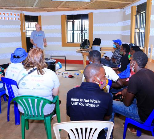 Professor Jeff Seay conducts a training session on the Trash-to-Tank Processor for the staff of Upcycle Africa in Mpigi, Uganda.