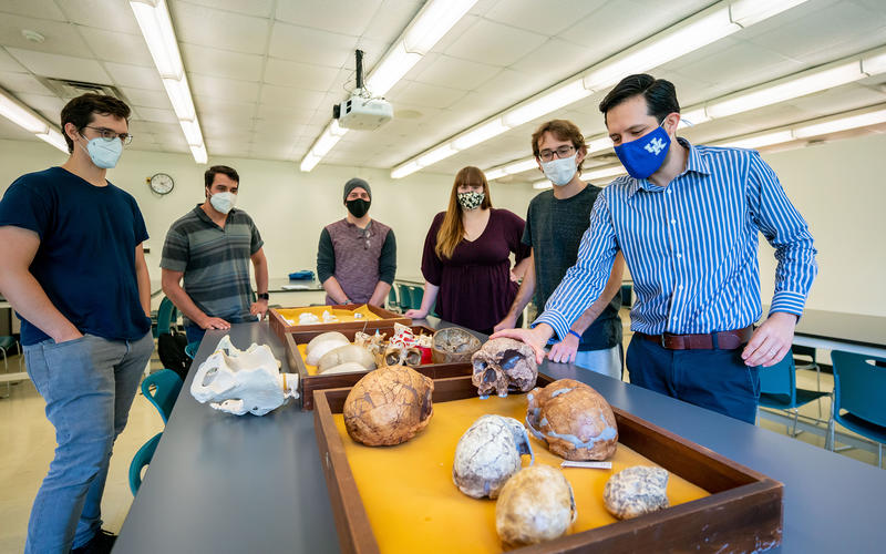 (From left) James Keppeler, Daniel Benitez, Marcus Rodriguez, Leah Blair, Bruno Athie Teruel and Hugo Reyes-Centeno, assistant professor of anthropology, examine artifacts from his human fossil record research. Photo Courtesy: UK Research.